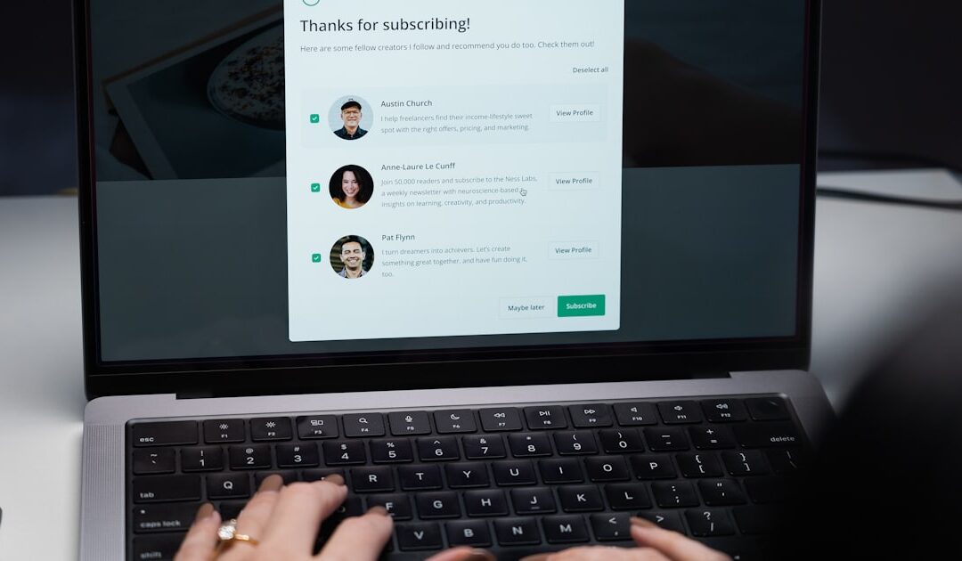 Hands typing an email at a laptop keyboard