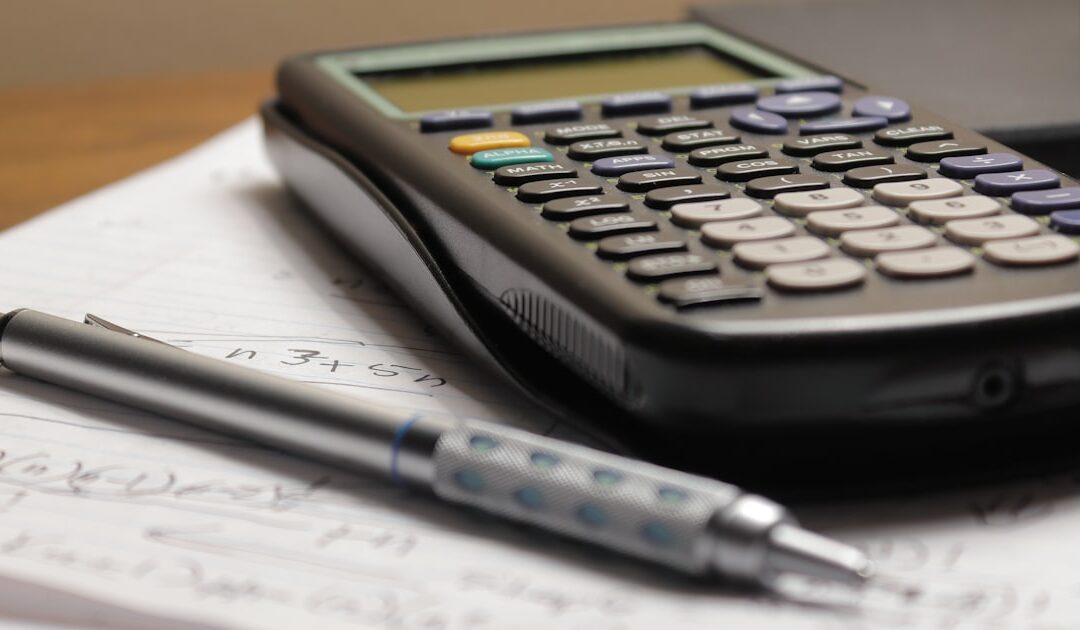 A calculator and pen resting on a printed quotation