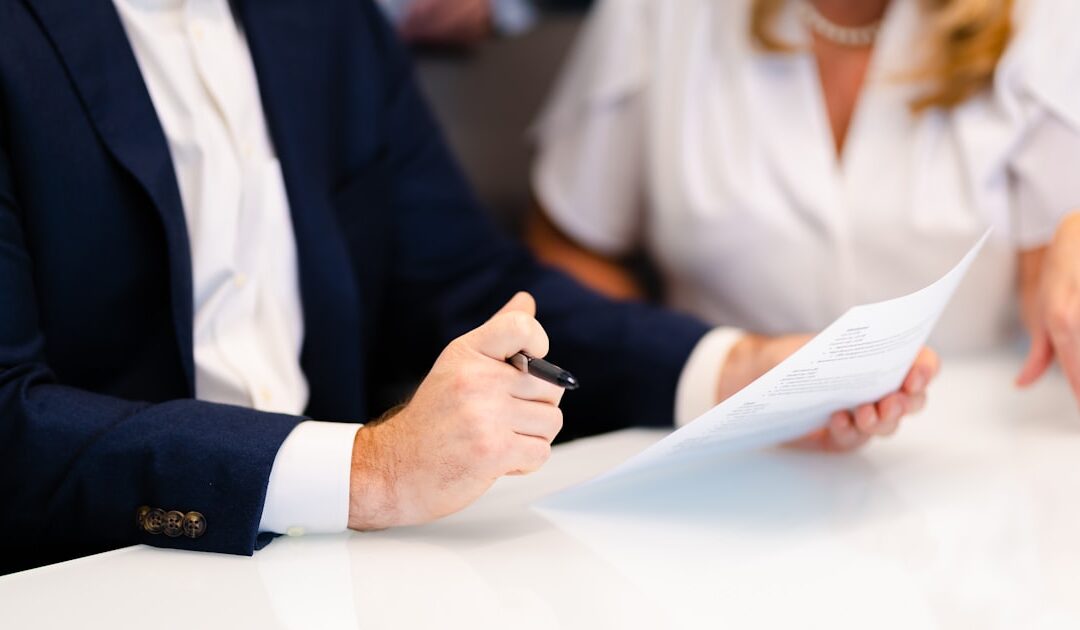 Two people going through a file across a table