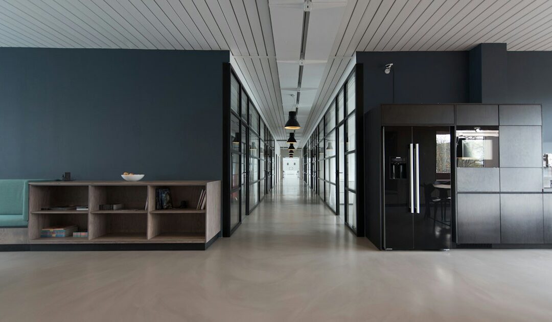 An open plan office with empty desks and monitors