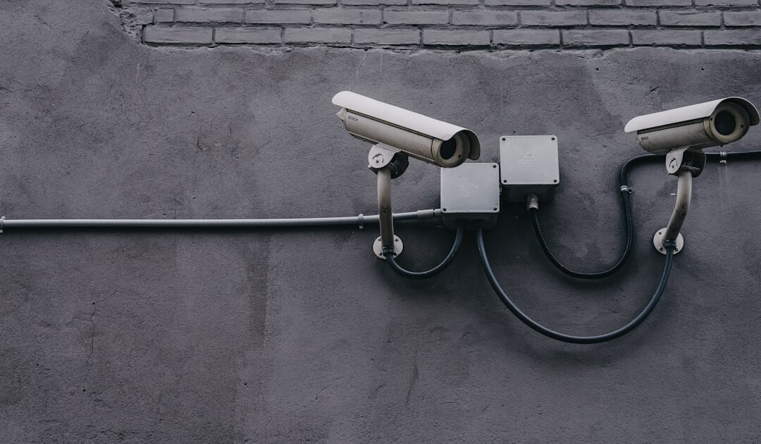 Two surveillance cameras mounted on an exterior wall