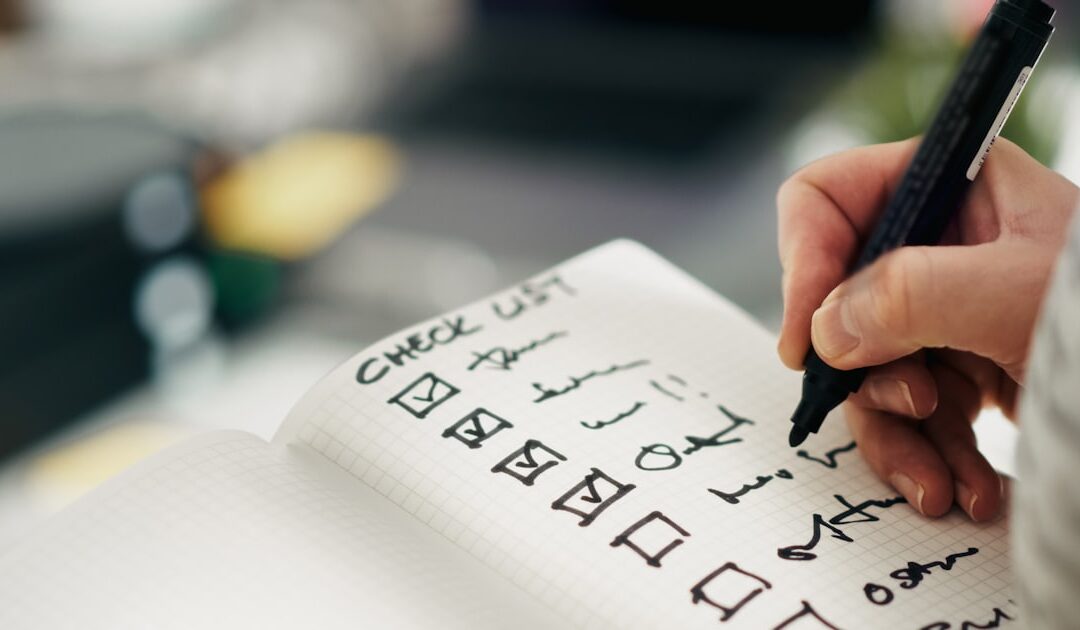 Someone working down a printed checklist, ticking items off