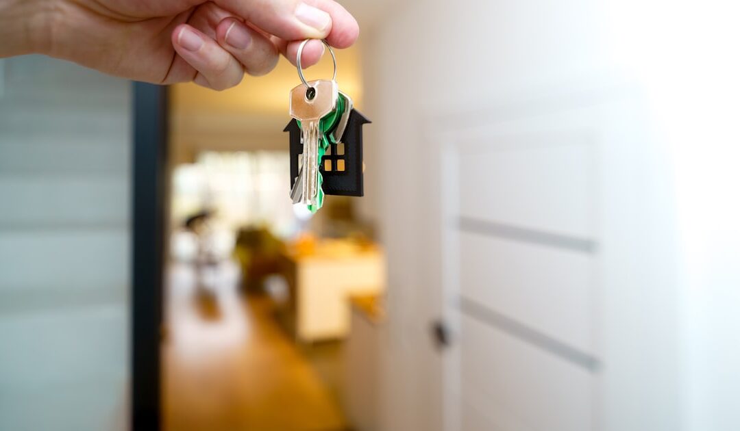 A set of house keys held up at the door of a property