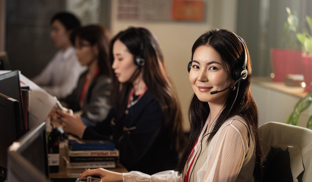 Somebody taking a call on a headset at their desk