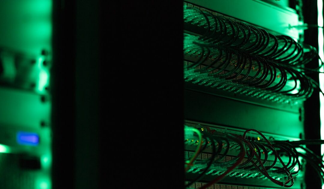 Networking equipment racked in a darkened room