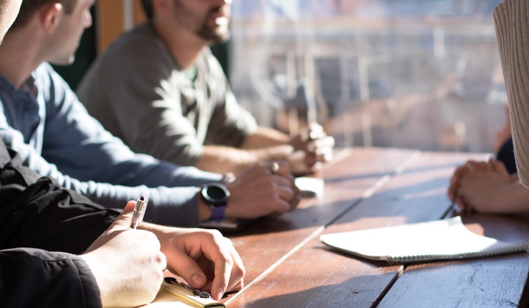 A group working through documents at a boardroom table