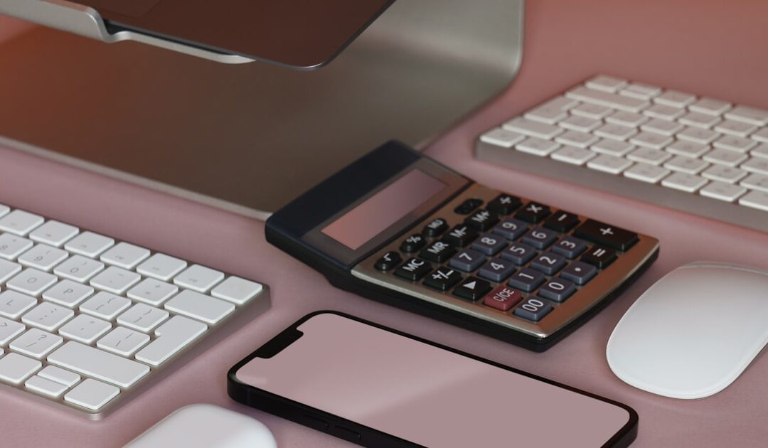 A working desk set up with keyboard, mouse and phone